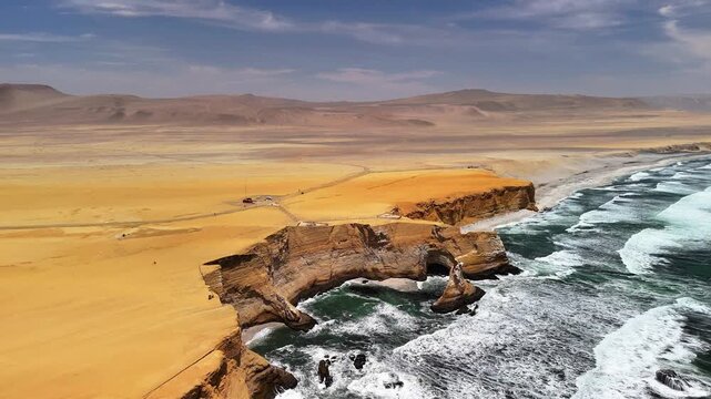 Aerial drone view of the Pacific Ocean and cliffs in Paracas. Dramatic Pacific landscape. Panoramic coastal view. Peru. Region Ica.	
