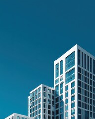 Crisp White Geometric Towers Ascending into a Flawless Deep Blue Sky.