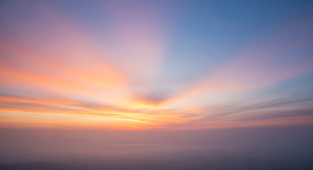 Colorful Sunset Sky with Beautiful Light Rays and Wispy Clouds Creating an Ethereal Atmosphere and Scenic Landscape