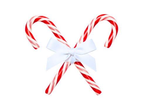 Two candy canes tied together with a white bow isolated on transparent background