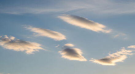 Wispy Cloudscape in Azure Sky With Sunlit Edges Gentle Sunlight Illuminating Billowy Masses of Vaporous Fluff in Open Expanse of Atmosphere