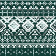 Ethnic geometric seamless pattern background. An intricate thai traditional and tribal motif. White ornament on green design for elegant textile, fabric, or wallpaper decoration