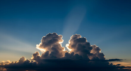 Sunlit Clouds on Blue Sky Reveals Dramatic Sunlight Beams Streaming Above Cumulus Cloud Formation in Weather Event with Natural Light Phenomena View