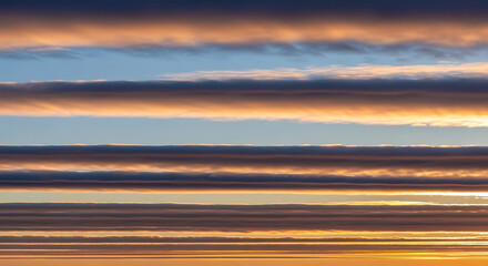 Layered Cloud Formations at Sunset Creating Horizontal Bands of Color in the Sky with Atmospheric Perspective and Stunning Visual Effect