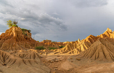 Panoramic Tatacoa Desert vista with ochre mounds under gray clouds