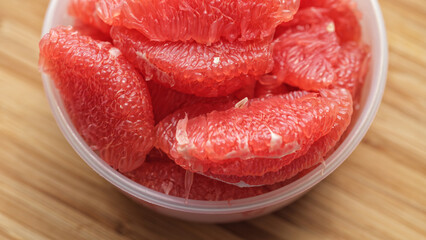 A bowl with grapefruit slices in it. Close up.