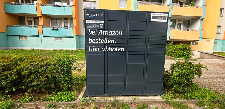 Berlin, Germany - July 14, 2025: Amazon Hub package locker in residential area with green surroundings