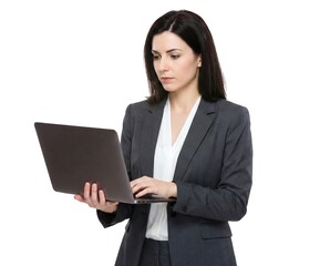 Professional businesswoman standing, focused on typing and working on a laptop computer.