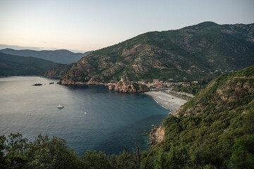 Obraz premium Aerial view town ruins Genoese tower of Porto Corsica France medieval watchtower Mediterranean Sea Calanches de Piana