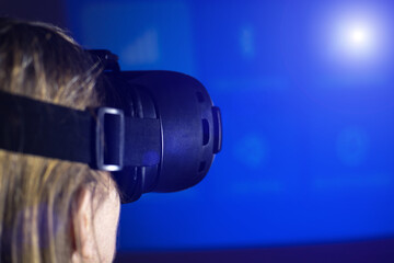 Woman in VR glasses. Virtual reality goggles. Have fun and learning at home. Modern technology concept.