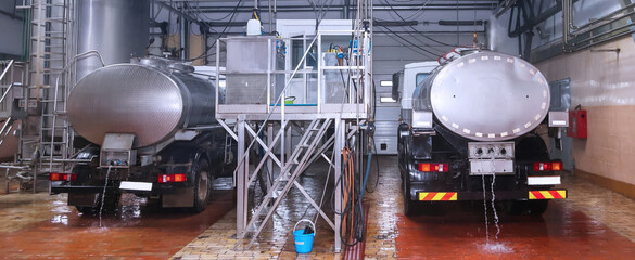 Tankers being cleaned at a dairy processing facility during daytime operations