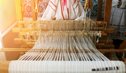 Weaver creating traditional textiles at a loom in a cultural workshop