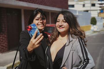 Fototapeta premium Two smiling adult women friends taking selfie
