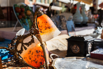 Old vintage lamp, a chandelier with colored glass at a flea market stall in Nice
