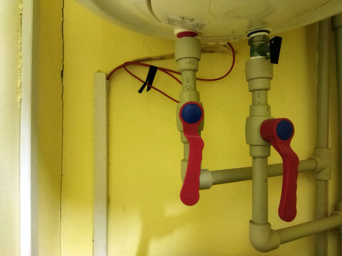Water heater valves and piping setup in a residential area