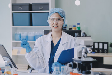 Portrait, science and happy woman on laptop in lab to research chemistry, test or innovation....