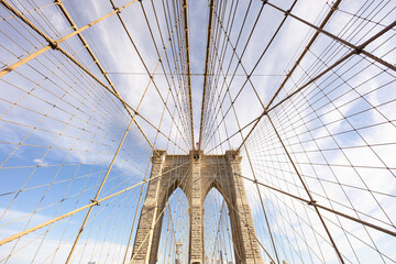 Naklejka premium The pedestrian section of the Brooklyn Bridge in New York City is empty of people during the day.