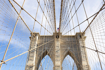 Obraz premium The pedestrian section of the Brooklyn Bridge in New York City is empty of people during the day.