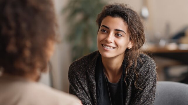 Two friends share a joyful moment deep in conversation surrounded by a relaxed atmosphere.
