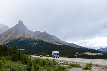 Camper driving through the Rocky Mountain landscape on the Icefield Parkway in Canada
