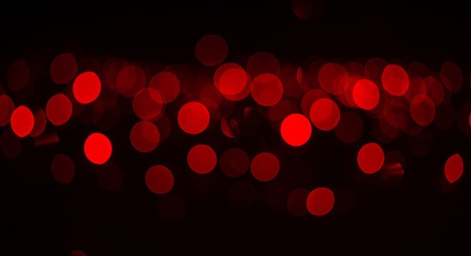 Abstract red bokeh lights on a dark background for holiday season