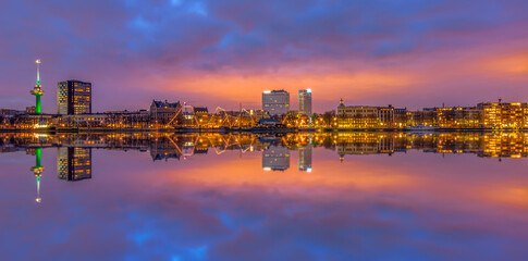 sunset over the city Rotterdam with beautiful reflection in river
