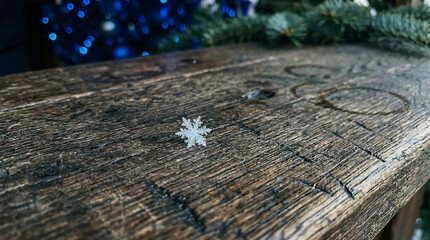 Macro detail of a weathered wooden stall counter with a single snowflake at a Christmas market