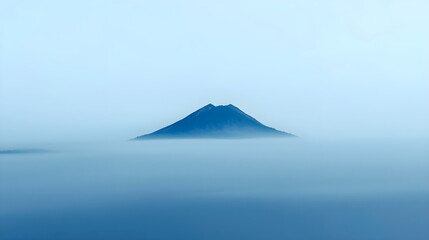 Mountain peak rising above blue fog minimalist landscape