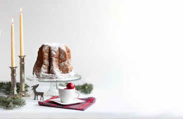 Christmas Table with Pandoro Cake, Candles and Festive Holiday Decor