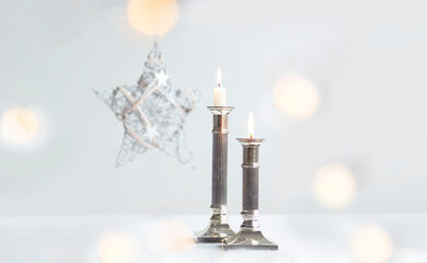 Elegant Christmas Candles with Silver Holders and Soft Bokeh Lights