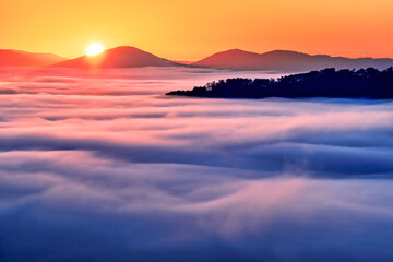 Sunrise in the Blue Ridge Mountains, viewed from above the richly colored, valley fog. 