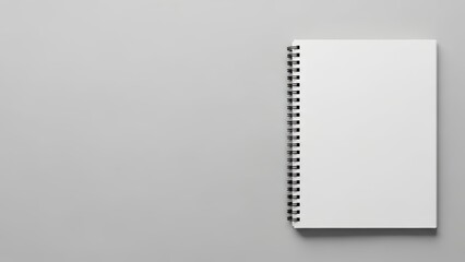 Blank spiral notebook on gray background for sketching and writing