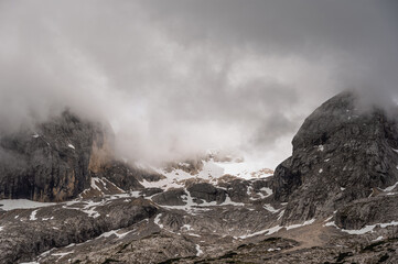 Marmolada mountain range seen from the viel del pan trail during a summer cloudy day, Canazei, Dolomites, Italy
