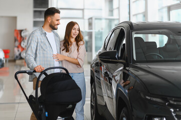 Happy family buying new suv at car dealership