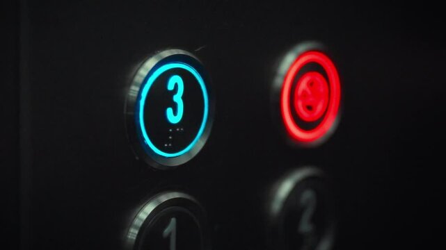 A man's finger is seen pressing the button for the third floor in an elevator. This moment captures everyday life in a busy building. The action indicates a desire to reach an upper level quickly
