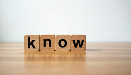 Four wooden cubes on light table spell word know. Image represents learning, wisdom, gaining knowledge. Conveys concepts of education, understanding, information transfer. Blocks stand on wooden