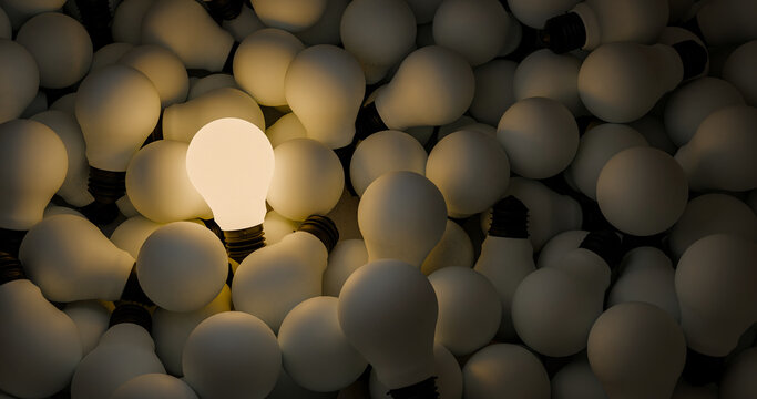 Single Illuminated Light Bulb in a Pile of Bulbs &ndash; Concept of Innovation and Thinking
