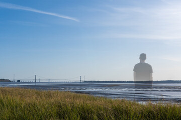 A mysterious ghost like transparent, missing person, standing by a river in summer,
