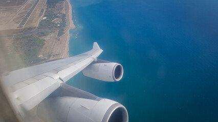 Airbus A340 flight shortly after takeoff from Barcelona's El Prat Airport, and a view of the seashore from the plane window
