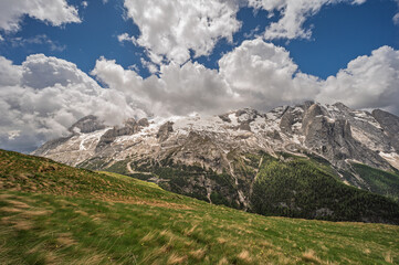 Marmolada mountain range seen from the viel del pan trail during a summer cloudy day, Canazei, Dolomites, Italy