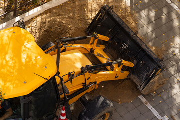 Yellow Front Loader Pushing Sand at Construction Site