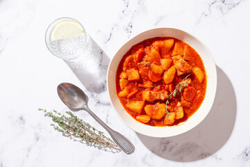 meat goulash with potatoes and carrots, sweet peppers, in a saucepan, top view, traditional Hungarian soup, homemade, no people,