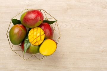 Fresh ripe mango on wooden background, top view