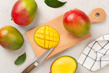 Fresh ripe mango on concrete background, top view