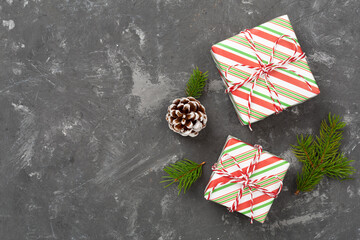 Striped Christmas gift boxes on concrete background, top view