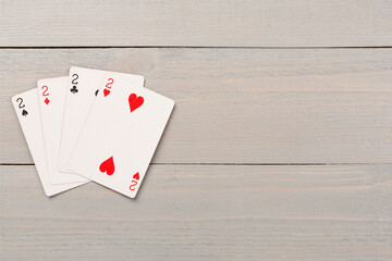 Poker chips and playing cards on wooden background, top view. Casino card game