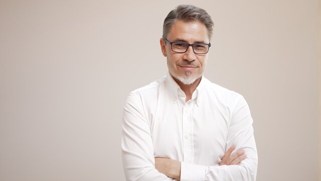 Middle age businessman in white business shirt. Casual entrepreneur. Portrait of mid adult, mature age man, happy smiling. Isolated on white, copy space.