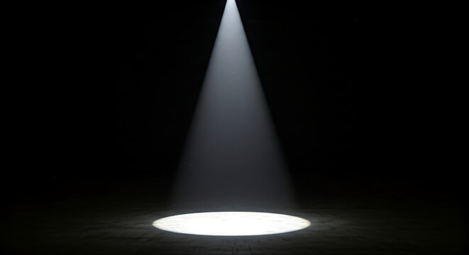 Single bright spotlight beam illuminating a dark stage with a circular pool of light