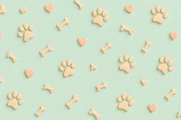 Soft pastel paw and bone pet pattern on mint green background
