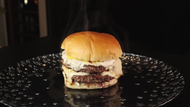 Steaming double deck burger with rare beef patties, melted cheese, homemade mayo, and mustard. Juicy, indulgent, and perfectly cooked in video.